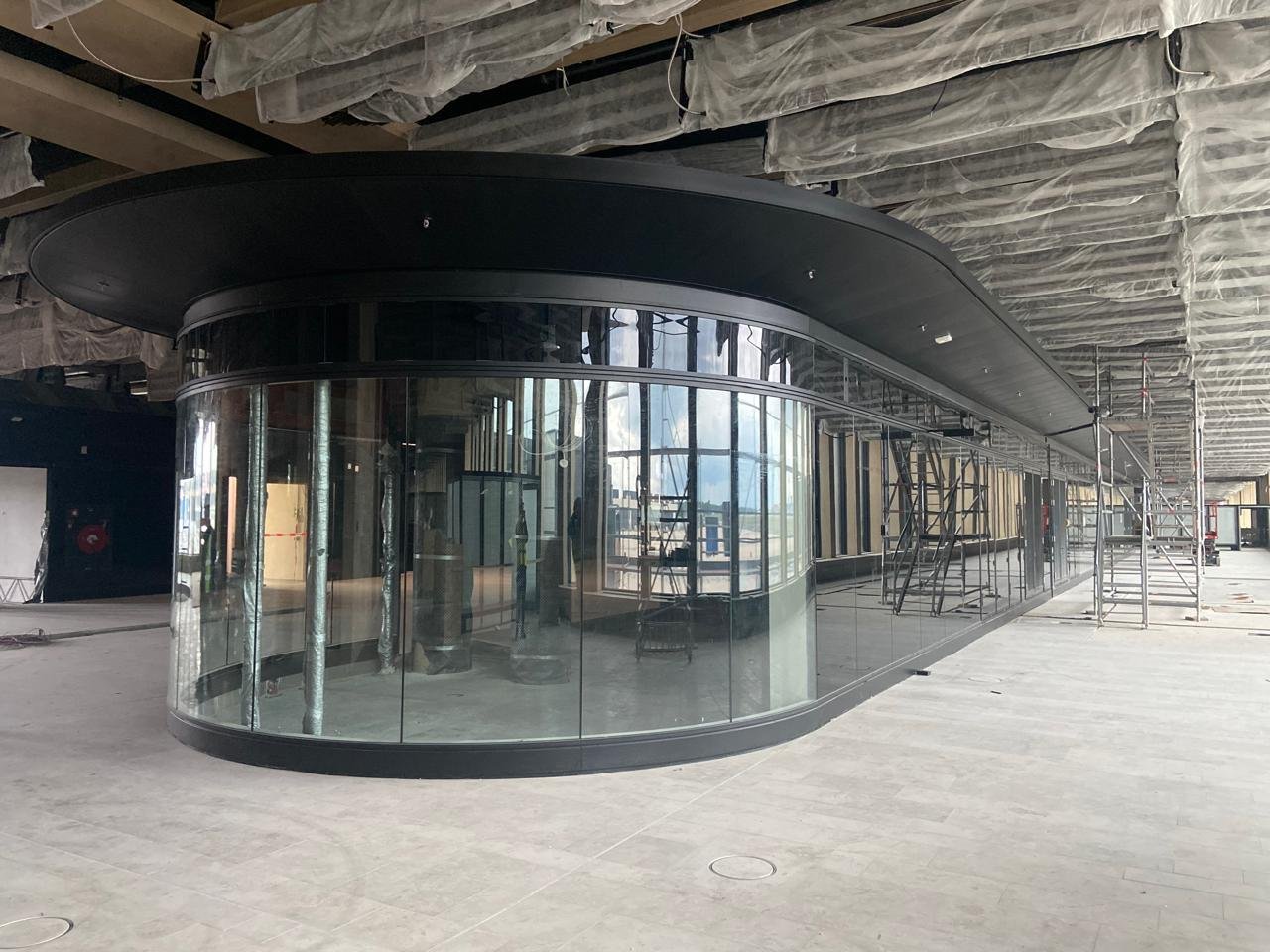 Curved steel-and-glass passenger box during construction, Terminal 3 Frankfurt Airport